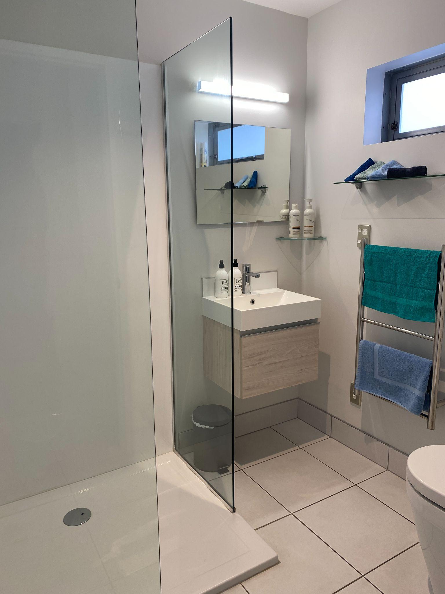 Modern bathroom with walk-in shower in the studio